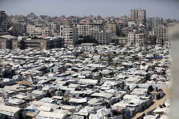 خيام تؤوي نازحين فلسطينيين على ساحل مدينة غزة وبين مبانٍ متضررة جراء الحرب، في 10 أغسطس/آب 2026. تصوير: بلال أسامة.