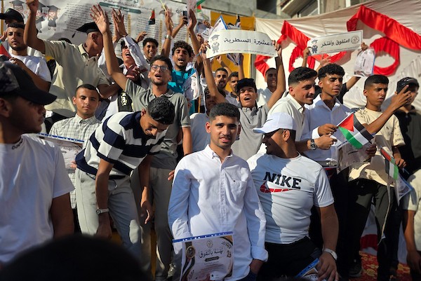 طلاب فلسطينيون متفوقون في المرحلة الثانوية برفقة عائلاتهم خلال حفل تكريم في خان يونس، جنوب قطاع غزة، في 6 أغسطس/آب 2026، احتفاءً بنجاح 140 طالبًا وطالبة رغم الظروف الصعبة. تصوير: طارق محمد