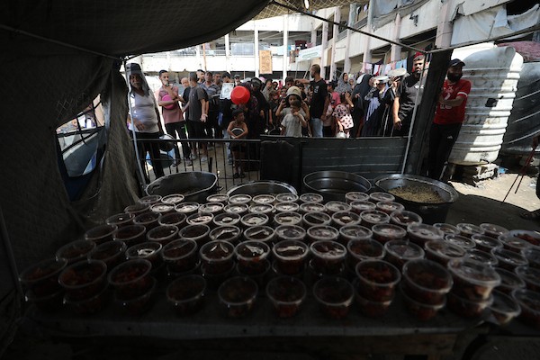 نازحون يحملون أواني الطعام والحاويات أثناء انتظارهم الحصول على وجبات من مطبخ خيري في شمال قطاع غزة، في 29 أغسطس/آب 2026. (تصوير: حسن الجدي)