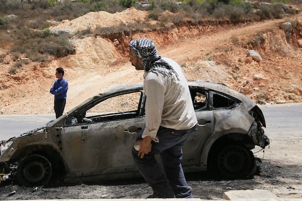 فلسطينيون يعاينون سيارات محترقة عقب هجوم لمستوطنين إسرائيليين استهدف منازل وممتلكات وخطوط كهرباء بين قريتي جالود وتلفيت، قرب نابلس، في 4 أغسطس/آب 2026. (تصوير: محمد ناصر)