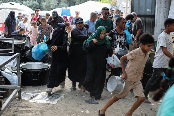 فلسطينيون نازحون، ينتظرون الحصول على وجبات ساخنة في مخيم النصيرات للاجئين وسط قطاع غزة، في 28 سبتمبر/أيلول 2026. (صورة: حسن الجدي)