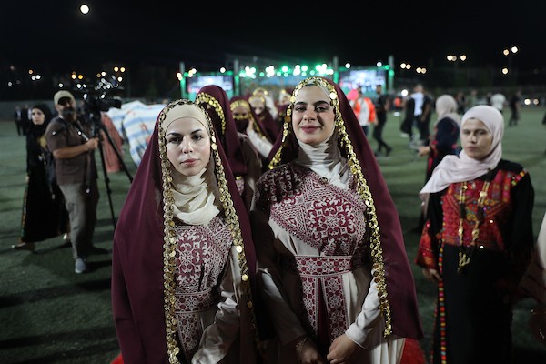 عرسان يشاركون في حفل زفاف جماعي ضم 44 زوجًا في مدينة دورا قرب الخليل، في 26 سبتمبر/أيلول 2026. تصوير: مأمون وزواز.