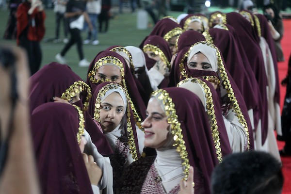 عرسان يشاركون في حفل زفاف جماعي ضم 44 زوجًا في مدينة دورا قرب الخليل، في 26 سبتمبر/أيلول 2026. تصوير: مأمون وزواز.