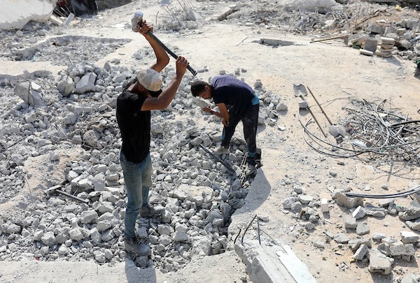 عمال فلسطينيون يزيلون أنقاض منزل دُمر في غارة إسرائيلية خلال الحرب في حي الرمال بمدينة غزة، في 14 سبتمبر/أيلول 2026. تصوير: بلال أسامة.