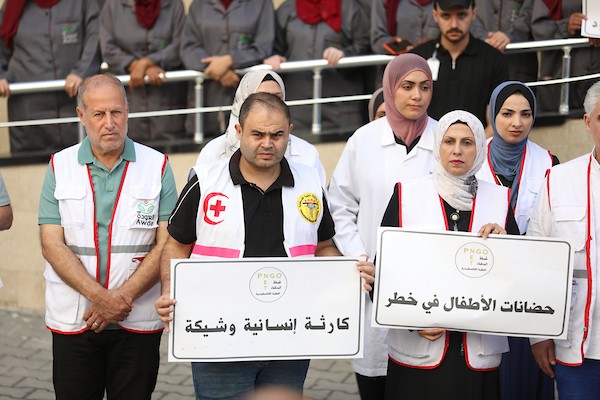 مشاركون من القطاع الصحي في شبكة المنظمات الأهلية الفلسطينية خلال مؤتمر صحفي أمام مجمع العودة الصحي والمجتمعي في مخيم النصيرات وسط قطاع غزة، في 20 سبتمبر/أيلول 2026 (صورة: حسن الجدي)