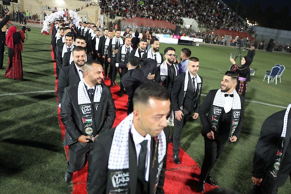 عرسان يشاركون في حفل زفاف جماعي ضم 44 زوجًا في مدينة دورا قرب الخليل، في 26 سبتمبر/أيلول 2026. تصوير: مأمون وزواز.