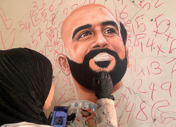 الفنانة الفلسطينية أسيل نسمان ترسم عملًا فنيًا على أنقاض منازل مدمرة في قطاع غزة، في 24 سبتمبر/أيلول 2026. (صورة: محمد صالحة)