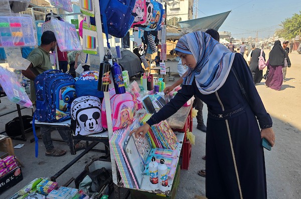 يتسوق فلسطينيون حقائب وأدوات مكتبية ولوازم مدرسية أخرى من أكشاك في سوق خان يونس، 13 سبتمبر/أيلول 2026. (صورة: طارق محمد