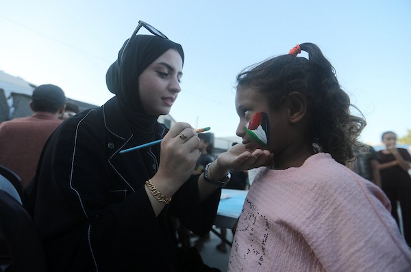 تجمّع أطفال فلسطينيون لمشاهدة عرض فيلم كرتوني في الهواء الطلق على شاشة نُصبت بين المباني المتضررة في مخيم للنازحين بحي النصر في مدينة غزة، وذلك في 2 سبتمبر/أيلول 2026.(صورة: بلال أسامة)