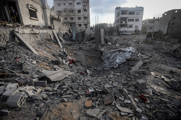 فلسطينيون يتفقدون ممتلكاتهم وسط أنقاض مبنى سكني استهدفته غارة جوية إسرائيلية في حي اليرموك بمدينة غزة، يوم 16 أكتوبر/تشرين الأول 2026. (تصوير: محمد صالحة)