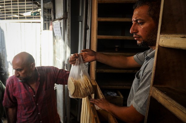 فلسطينيون ينتظرون الحصول على الخبز أمام مخبز في حي الدرج بمدينة غزة، وسط تحذيرات من توقف المخابز المتبقية بسبب نفاد الطحين، 22 أكتوبر 2026. (تصوير: محمد صالحة)