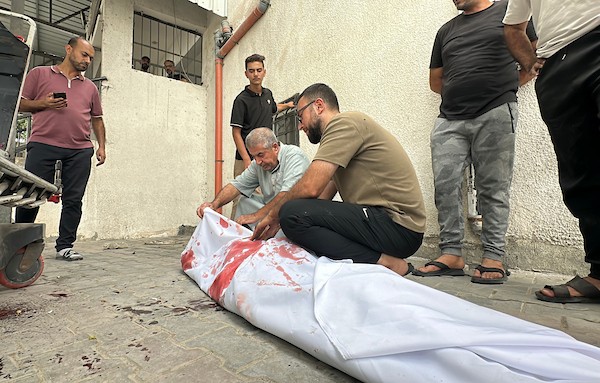 فلسطينيون ينوحون على رجل في مستشفى الشفاء بعد استشهاده في غارة جوية إسرائيلية استهدفت خيمة في مدينة غزة، في 2 أكتوبر/تشرين الأول 2026. صورة: هادي داود