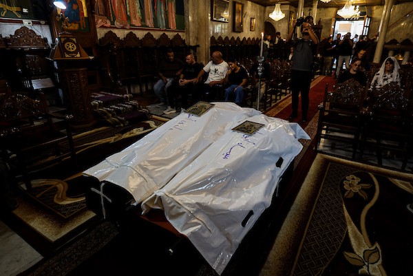 أشخاص يتجمعون خلال جنازة امرأتين مسيحيتين (أم و ابنتها) فلسطينيتين في كنيسة القديس بورفيريوس للروم الأرثوذكس في مدينة غزة، في 3 أكتوبر 2026. تصوير بلال أسامة